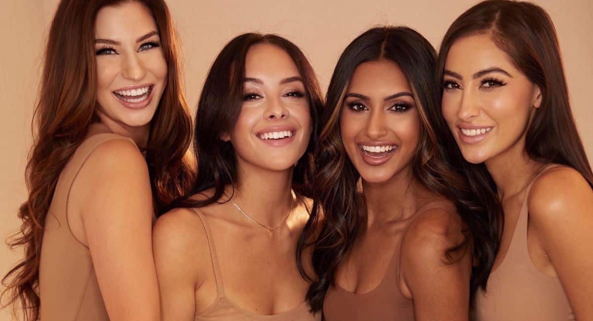 A bunch of stunning women are smiling.