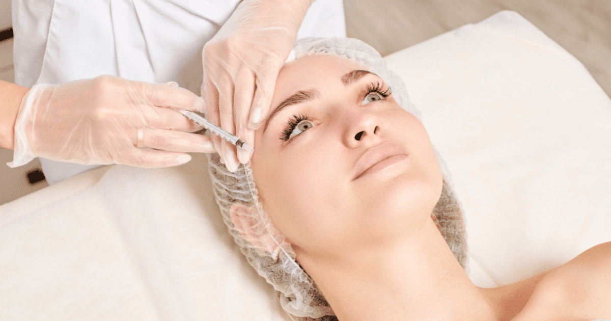 a woman receiving facial treatment