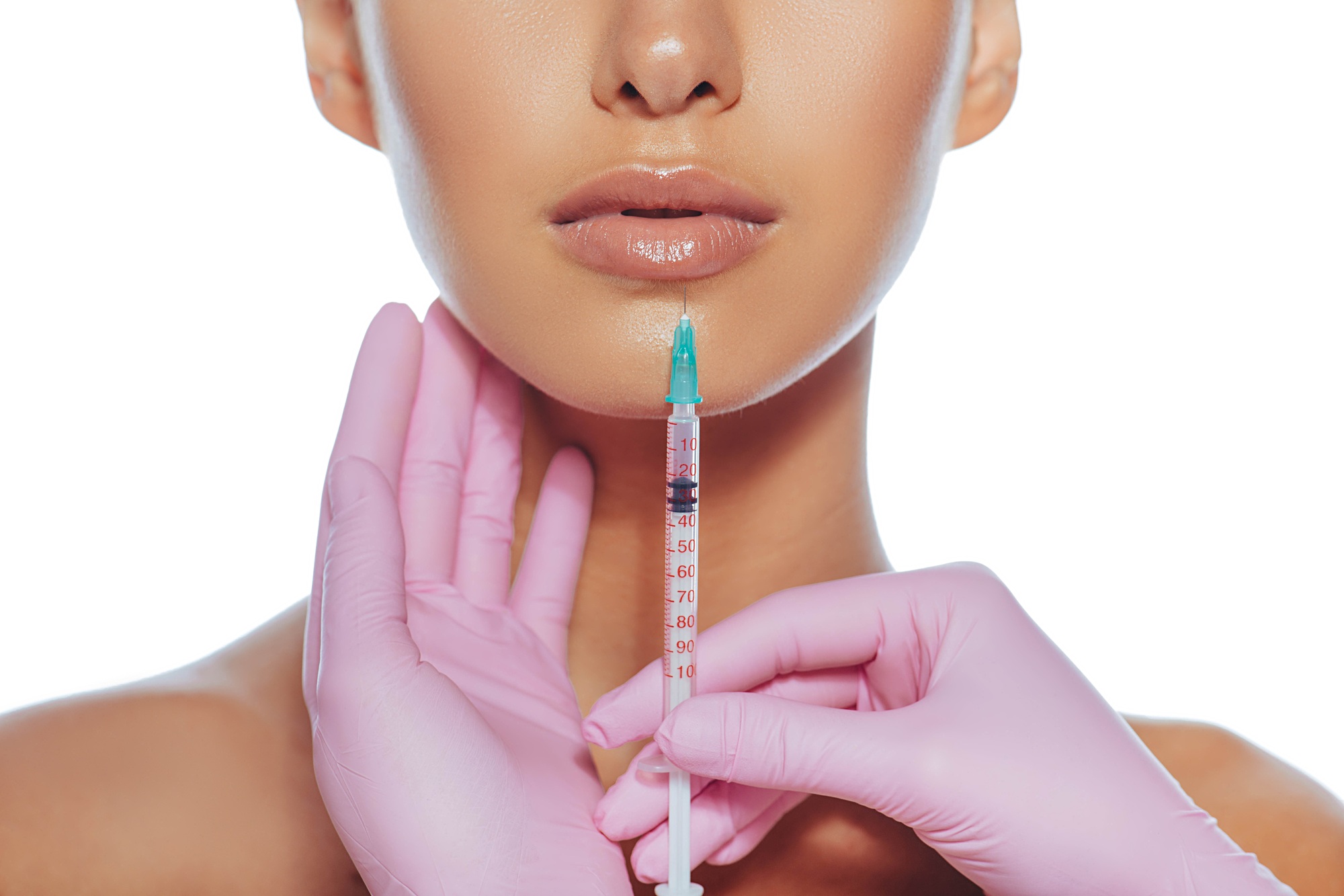 Cropped sensual female lips, procedure lip augmentation. Syringe near womans mouth