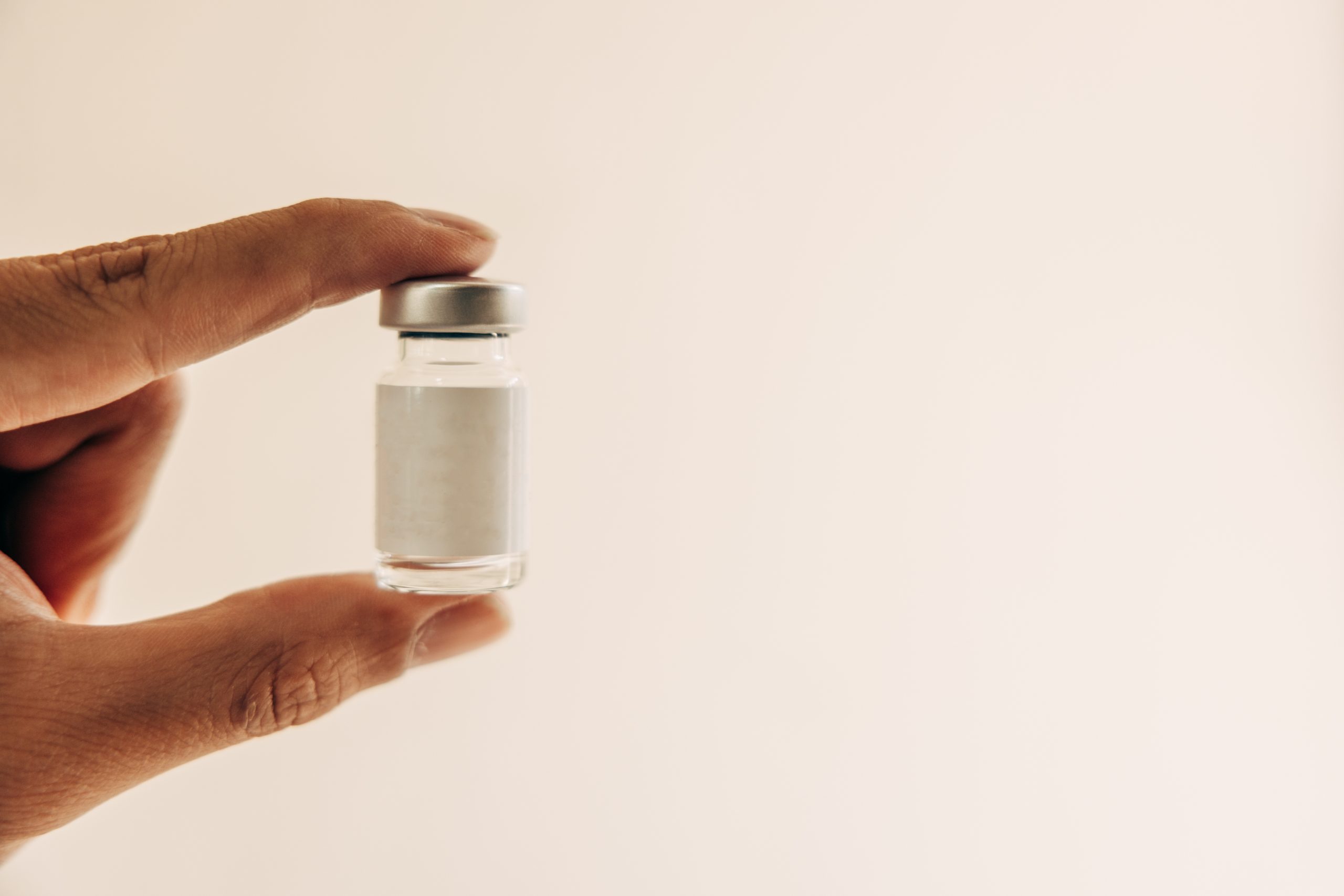 hand holding vial of filler botox